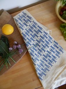 A customized tea towel with fish on it 