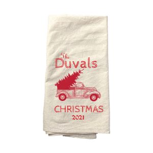 A personalized tea towel with a Christmas tree on it