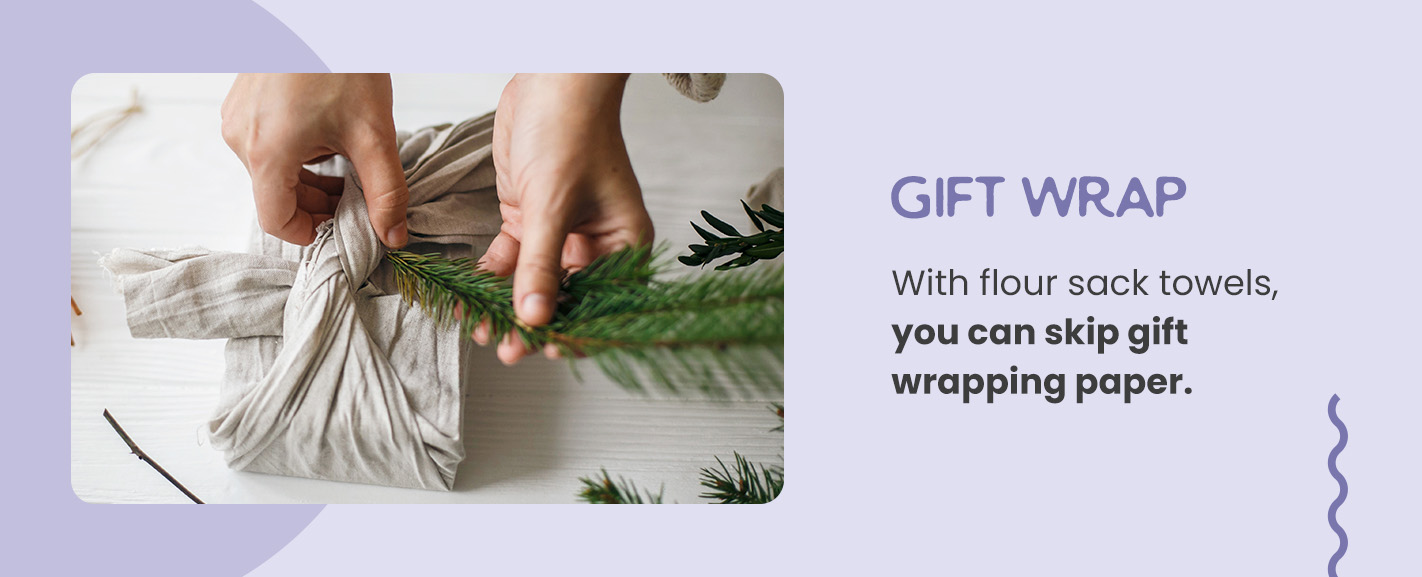 Image of a person wrapping a gift in a cotton flour sack towel.