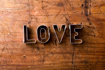 valentines-day-composition-studio-shot-on-brown-wooden-background-SBI-305195576-scaled-1